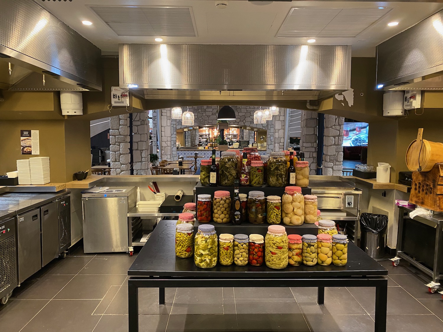 a kitchen with jars of pickles and vegetables